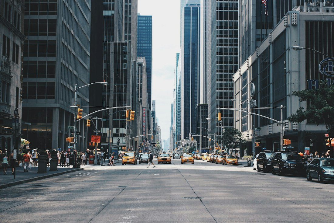 An urban street with buildings and road traffic
